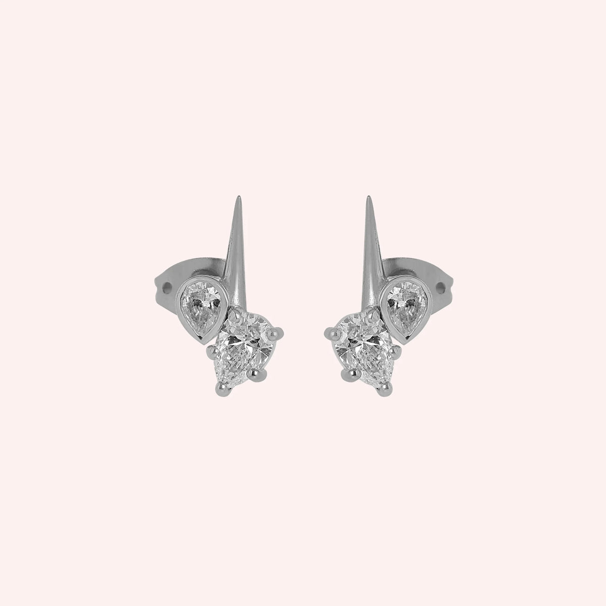Diamond_stud_earrings_in_sterling_silver_with_teardrop_shaped_diamonds_at_front_angle_view_on_solid_pink_background