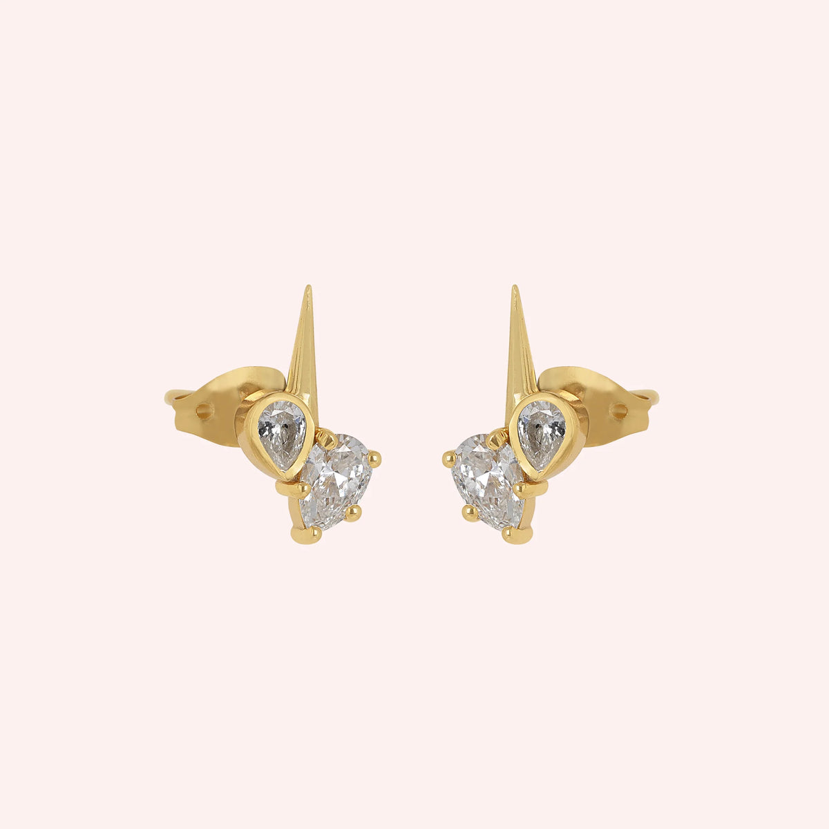 Diamond_stud_earrings_in_gold_plated_silver_with_teardrop_shaped_diamonds_at_slight_angle_view_on_solid_pink_background