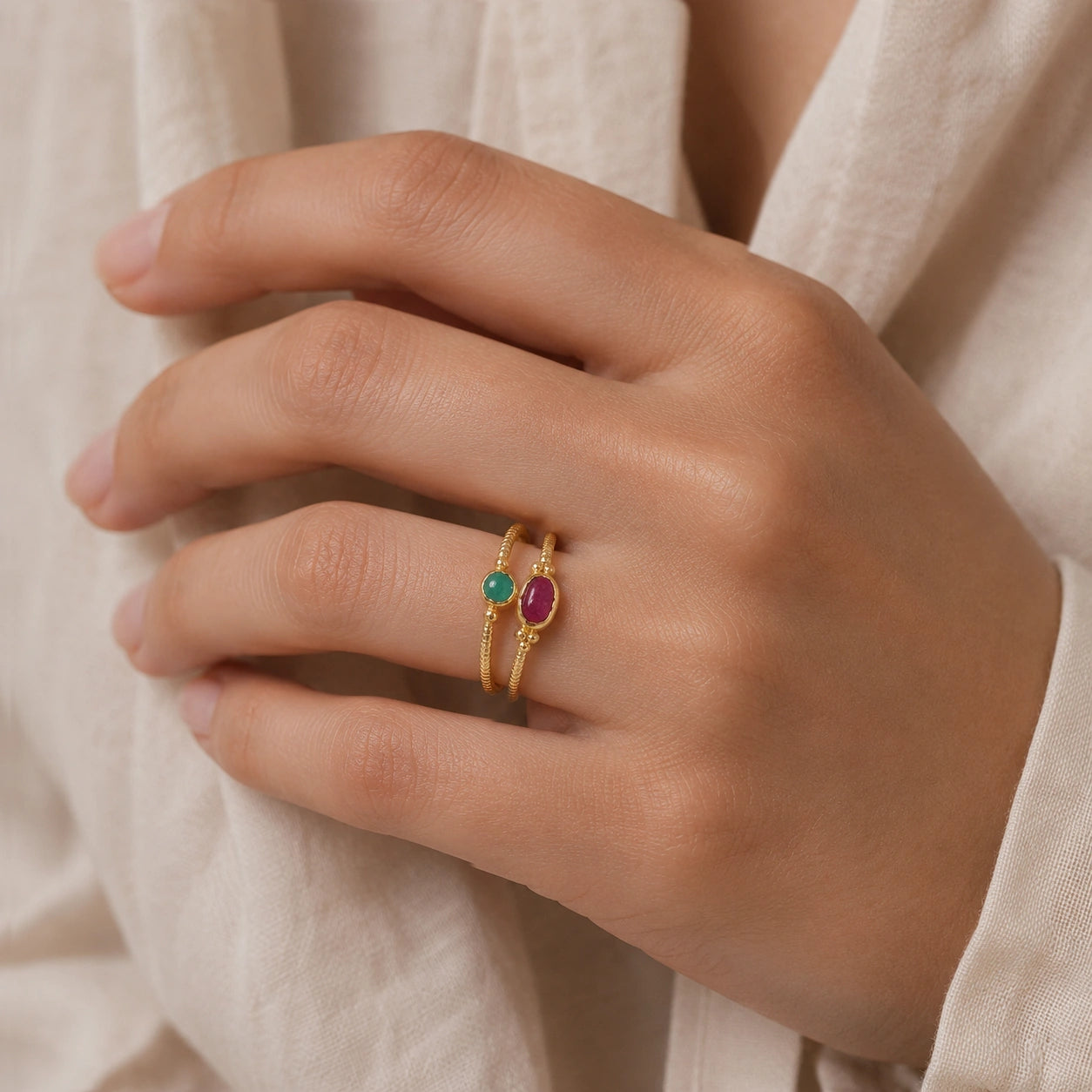 Double_stone_ring_in_gold_plated_silver_with_ruby_and_green_onyx_stones_worn_by_a_model