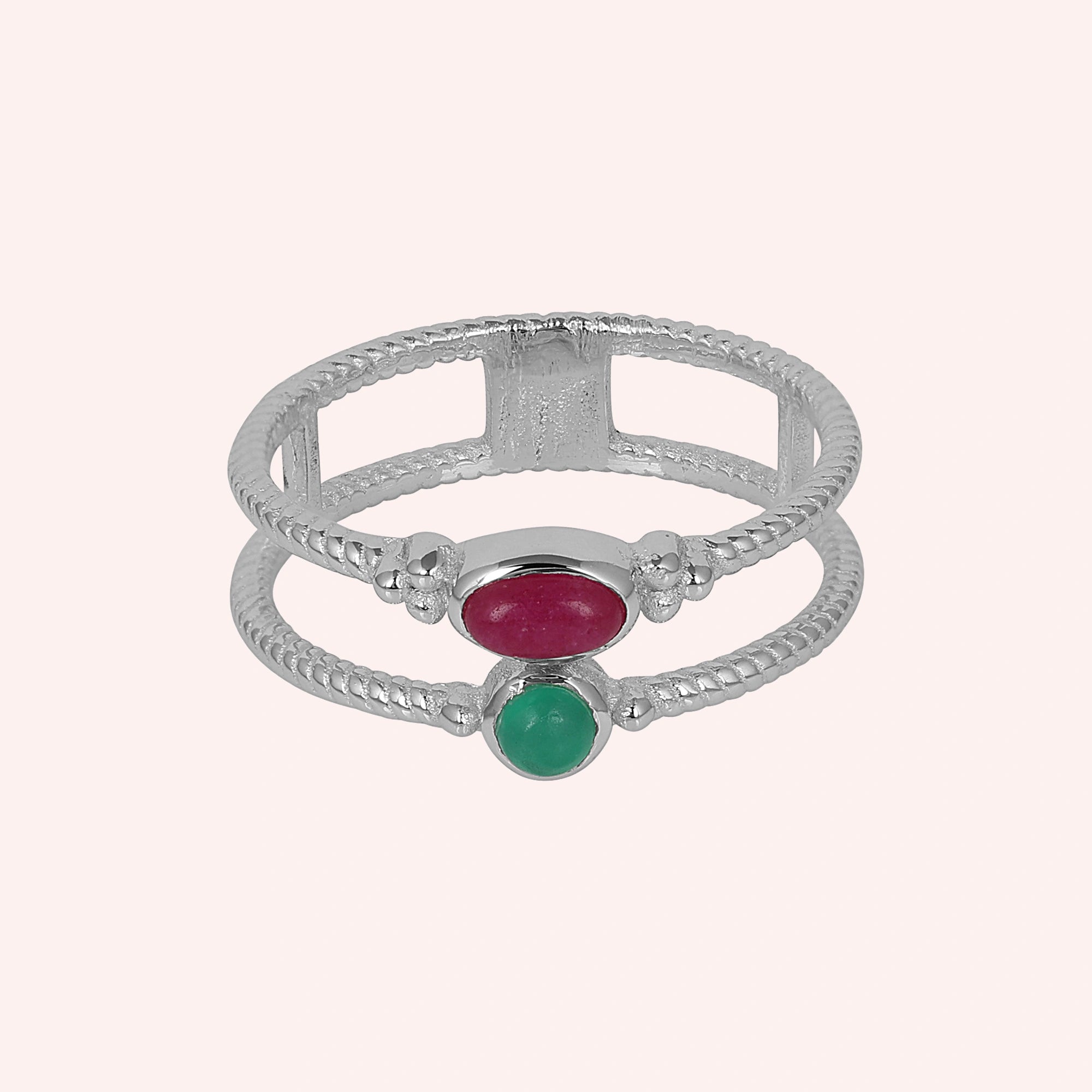 Double_stone_ring_in_sterling_silver_in_front_angle_with_ruby_and_green_onyx_stones_on_solid_pink_background