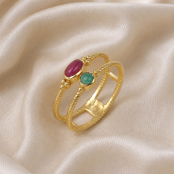 Double_stone_ring_in_gold_plated_silver_in_slightly_angle_with_ruby_and_green_onyx_stones_on_soft_fabric_background