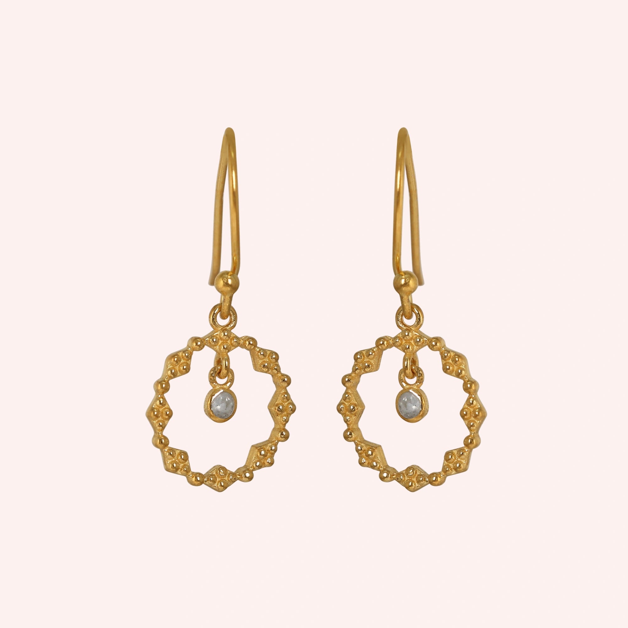 Drop_earrings_gold_plated_silver_with_textured_design_and_labradorite_stone_in_front_angle_on_solid_pink_background