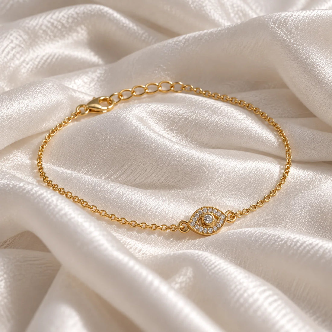 Evil_eye_bracelet_in_gold_plated_silver_with_lab_grown_diamonds_at_slight_angle_view_on_soft_fabric_background