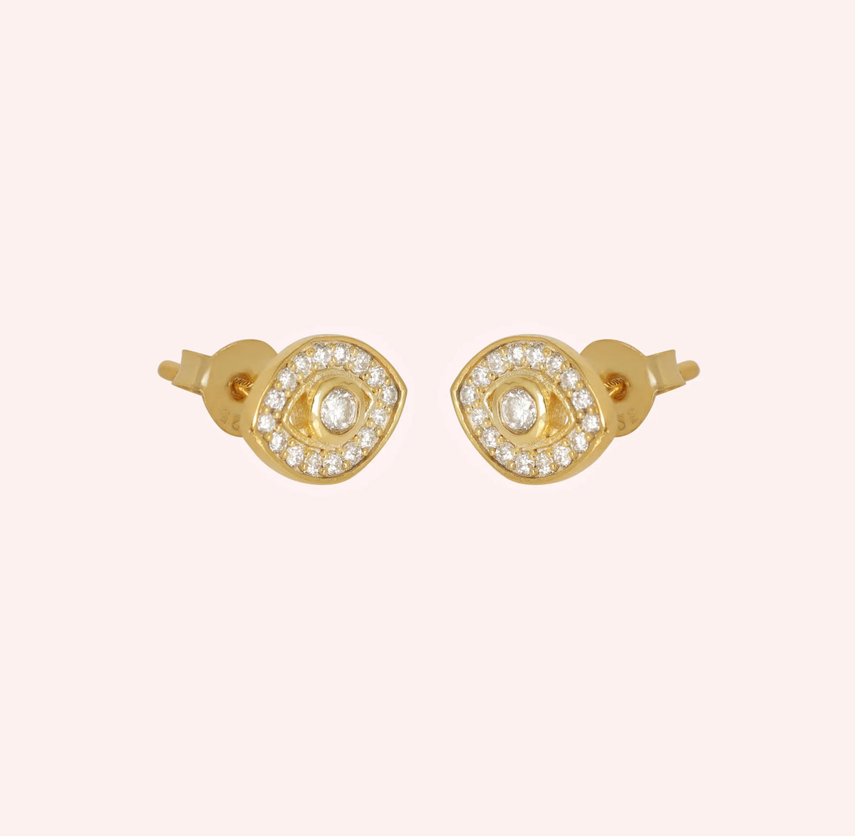 Evil_eye_earrings_in_gold_plated_silver_with_CZ_stones_at_side_angle_view_on_solid_pink_background