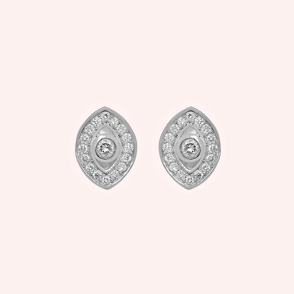 Evil_eye_earrings_in_sterling_silver_with_CZ_stones_at_front_angle_view_on_solid_pink_background