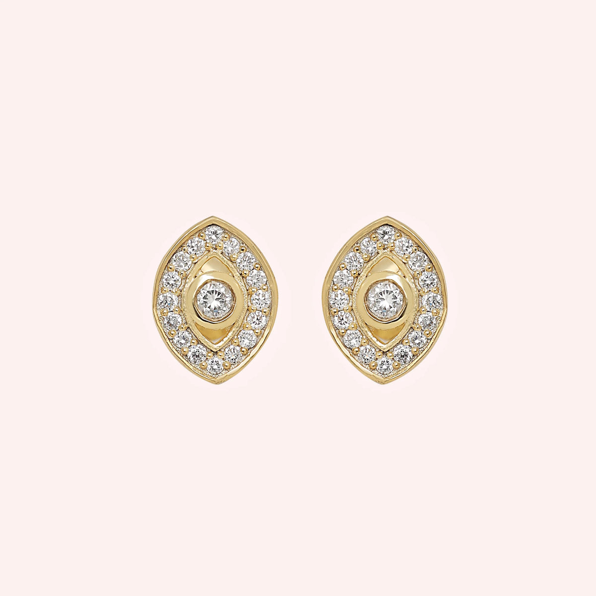 Evil_eye_earrings_in_gold_plated_silver_with_CZ_stones_at_front_angle_view_on_solid_pink_background