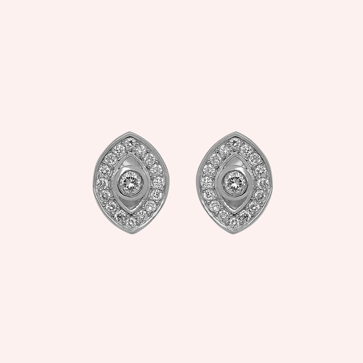 Evil_eye_earrings_in_sterling_silver_with_lab_grown_diamonds_at_front_angle_view_on_solid_pink_background