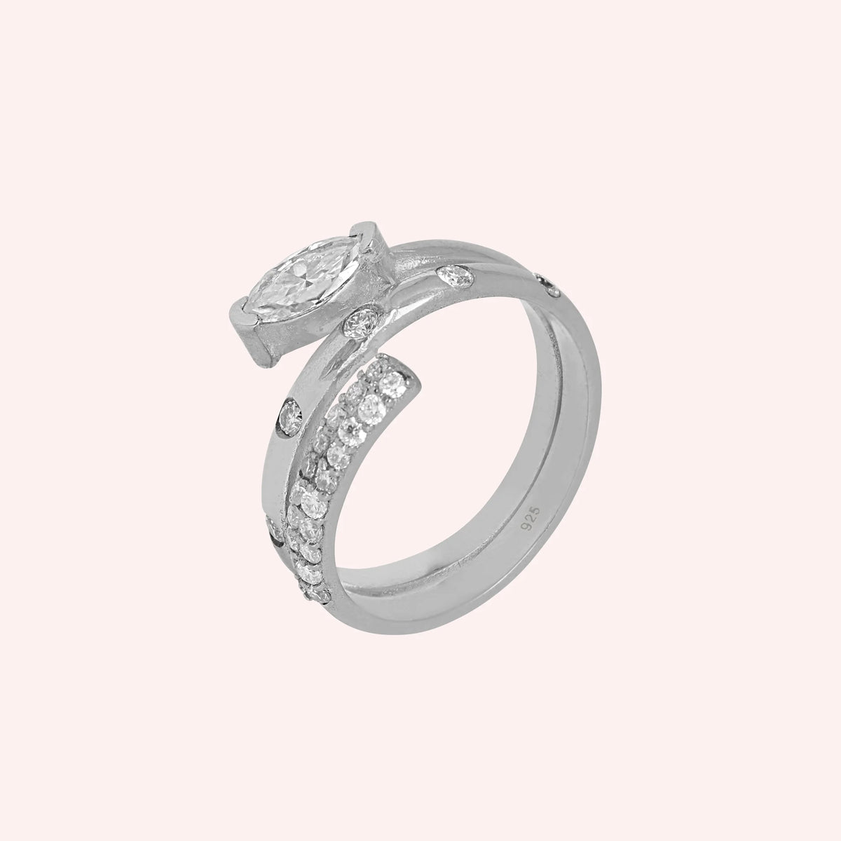 Fashion_ring_in_sterling_silver_with_a_spiral_design_and_lab_grown_diamonds_at_side_angle_view_on_solid_pink_background