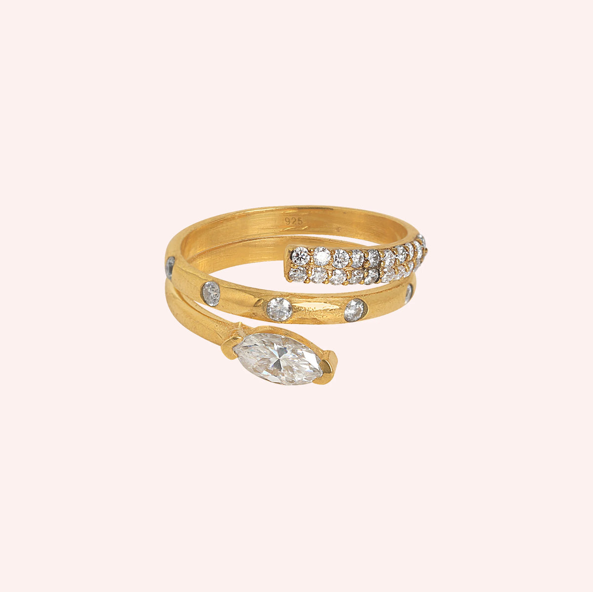 Fashion_ring_in_gold_plated_silver_with_a_spiral_design_and_lab_grown_diamonds_at_front_angle_view_on_solid_pink_background