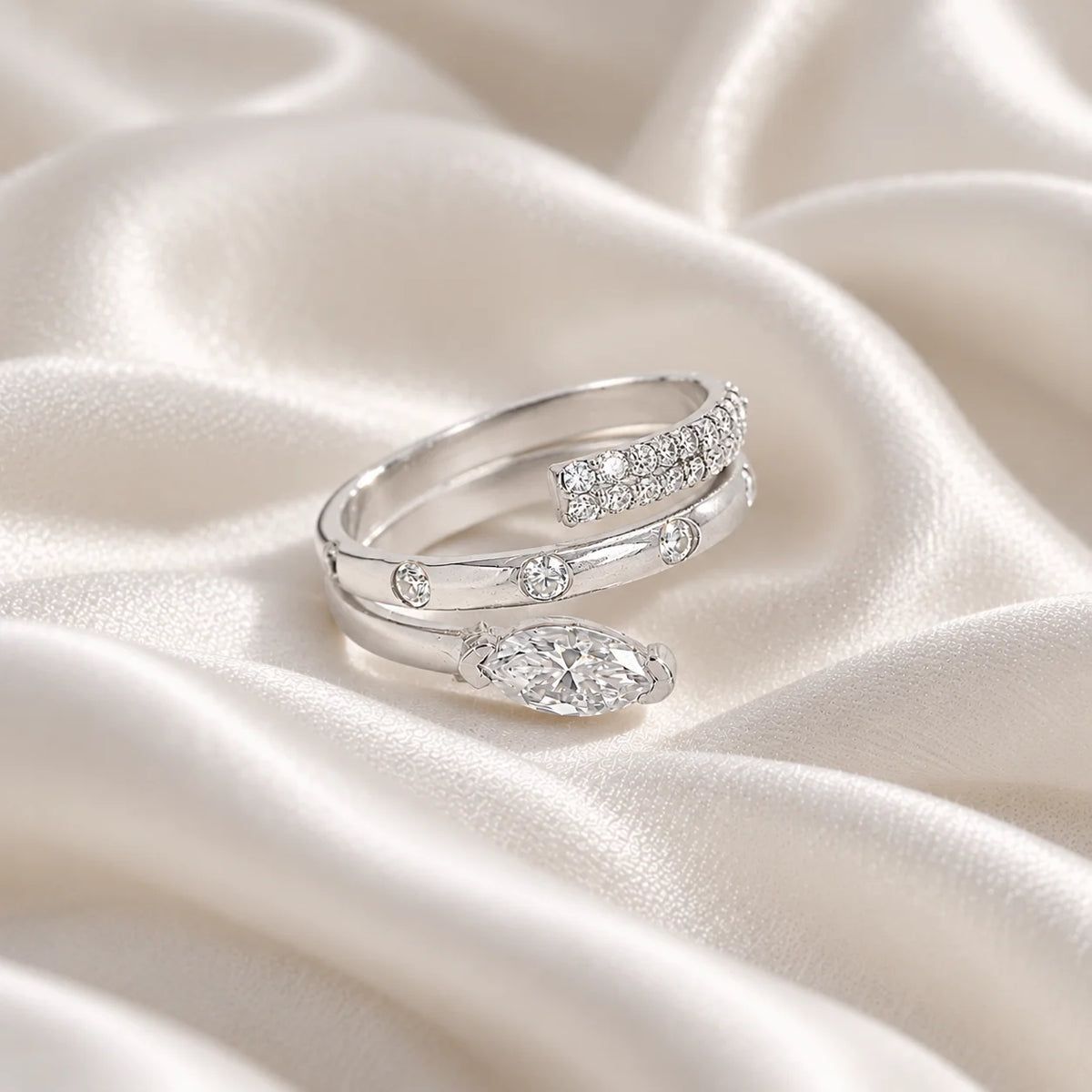 Fashion_ring_in_sterling_silver_with_a_spiral_design_and_lab_grown_diamonds_at_side_angle_view_on_soft_fabric_background