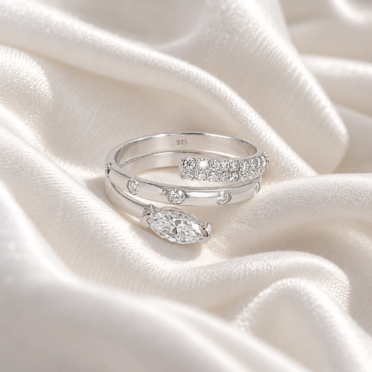 Fashion_ring_in_sterling_silver_with_a_spiral_design_and_lab_grown_diamonds_at_front_angle_view_on_soft_fabric_background