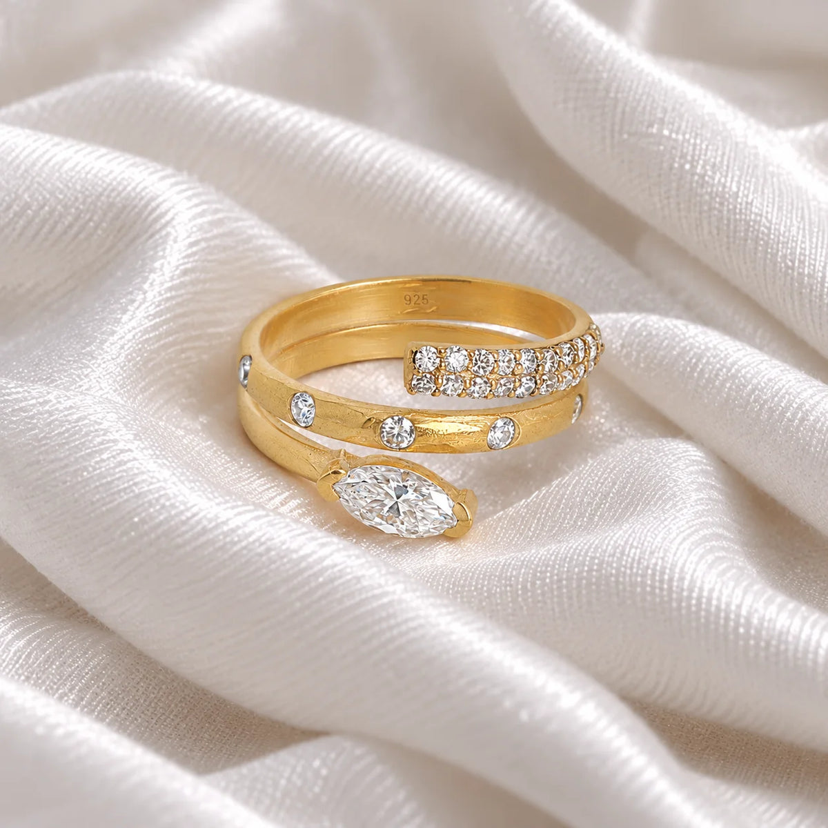 Fashion_ring_in_gold_plated_silver_with_a_spiral_design_and_lab_grown_diamonds_at_front_angle_view_on_soft_fabric_background