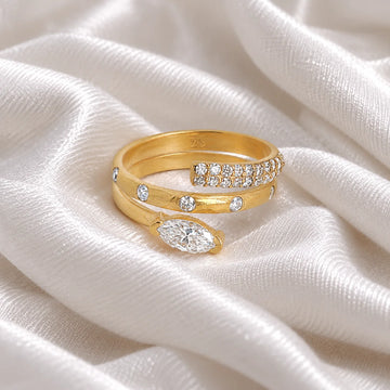 Fashion_ring_in_gold_plated_silver_with_a_spiral_design_and_lab_grown_diamonds_at_front_angle_view_on_soft_fabric_background