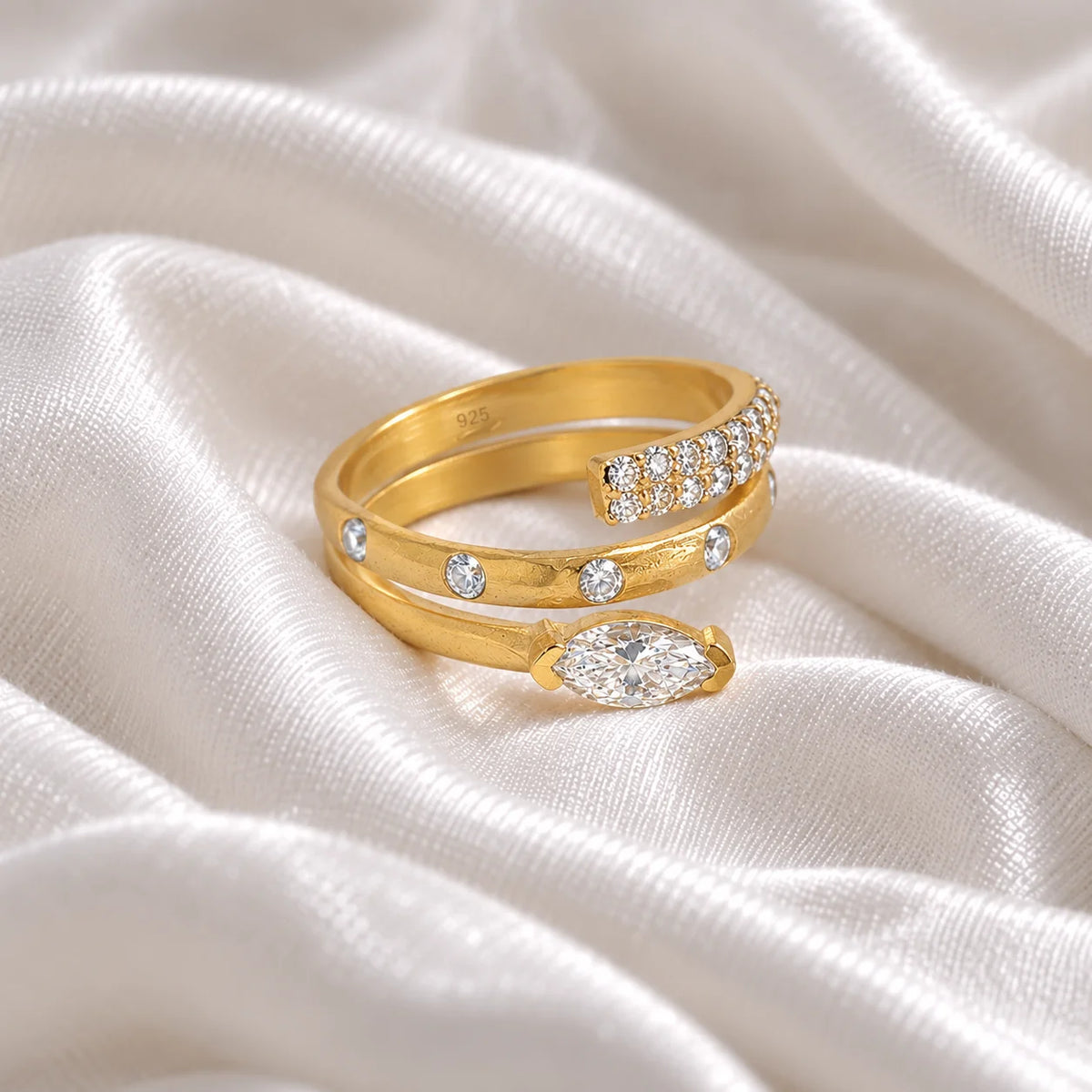 Fashion_ring_in_gold_plated_silver_with_a_spiral_design_and_lab_grown_diamonds_at_side_angle_view_on_soft_fabric_background