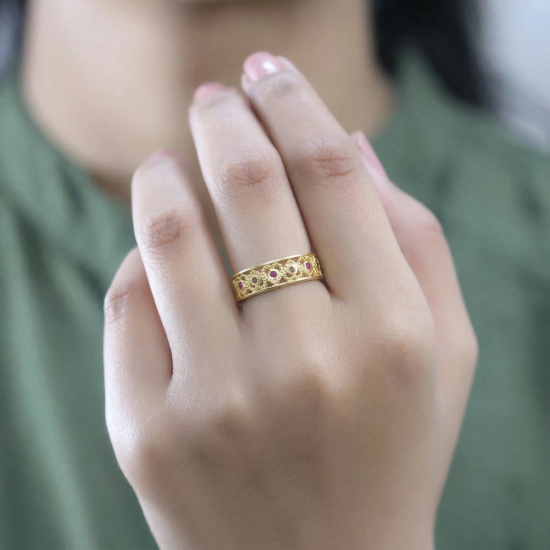 Filigree-ring-with-ruby-and-garnet-stones-gold-plated-silver-angled-view-on-white-satin-background