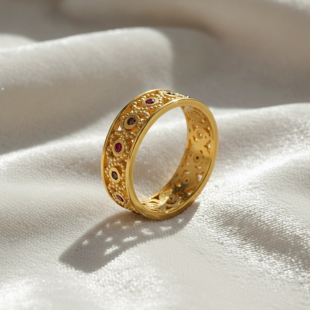 Filigree-ring-with-ruby-and-garnet-stones-gold-plated-silver-angled-view-on-white-satin-background