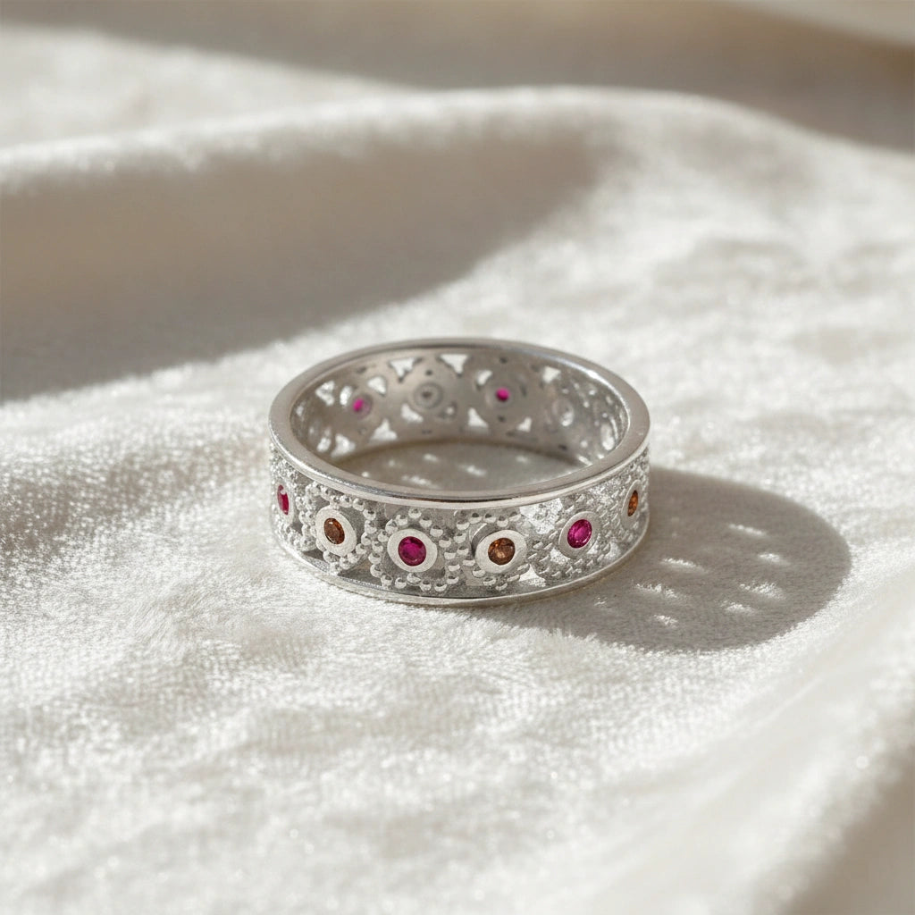 Filigree-ring-with-ruby-and-garnet-stones-sterling-silver-front-view-on-white-satin-background
