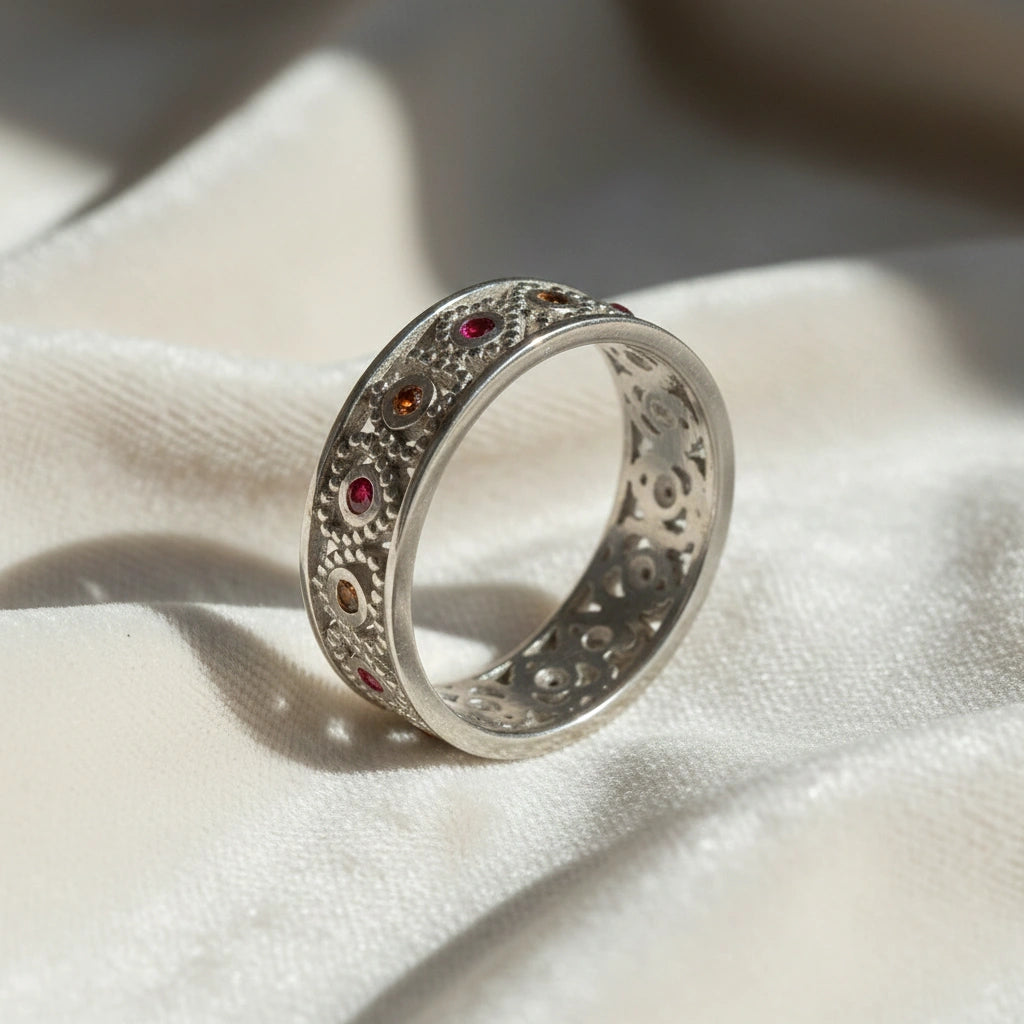 Filigree-ring-with-ruby-and-garnet-stones-sterling-silver-angled-view-on-white-satin-background