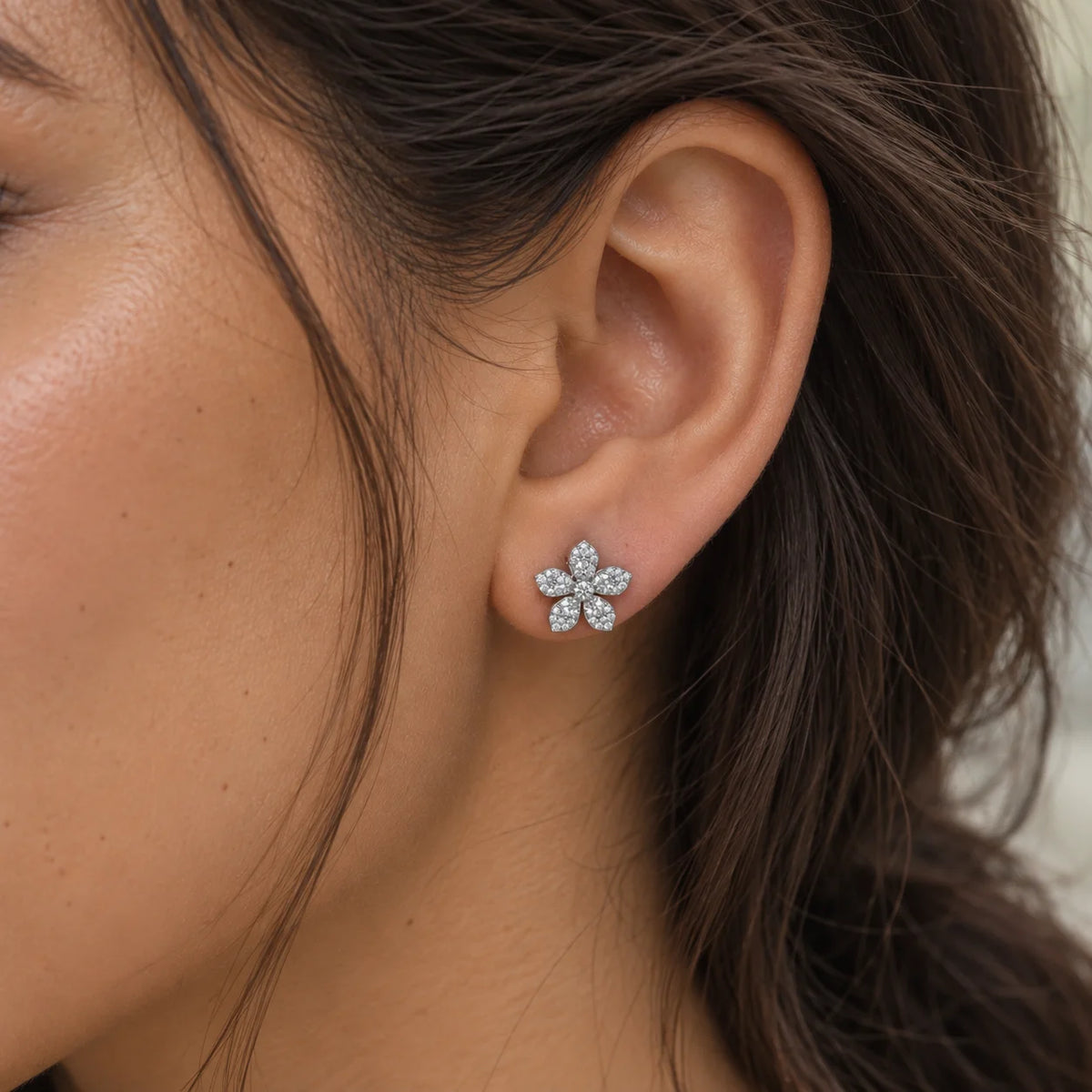 Flower_earrings_in_sterling_silver_with_lab_grown_diamonds_at_side_angle_view_worn_by_a_model