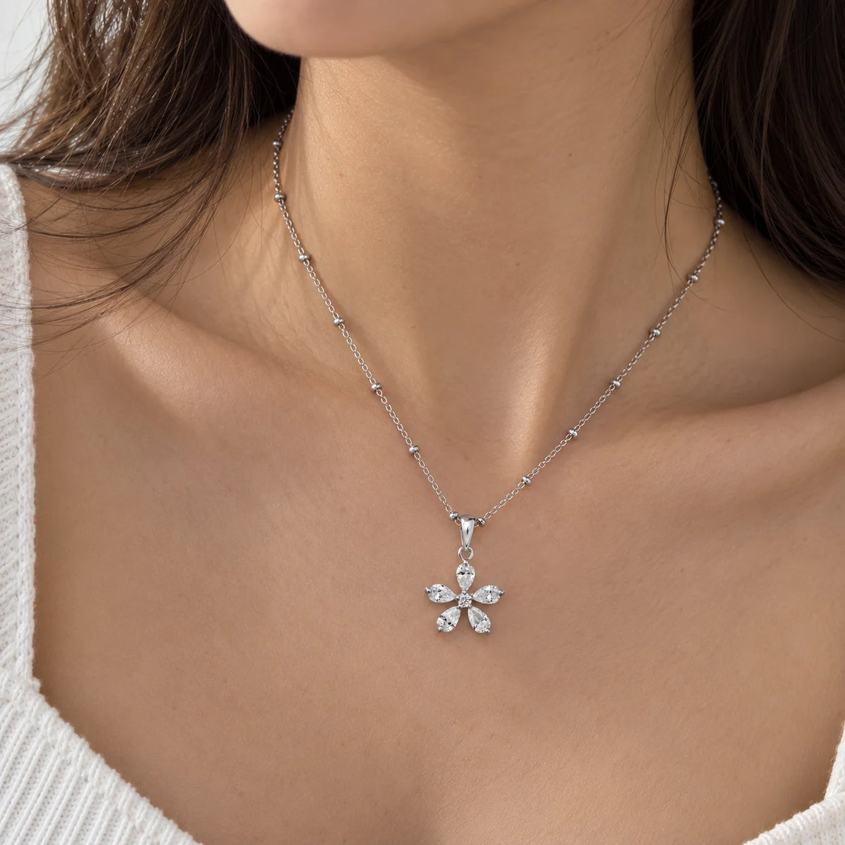 Flower_necklace_in_gold_plated_silver_with_lab_grown_diamonds_at_front_angle_view_worn_by_a_model