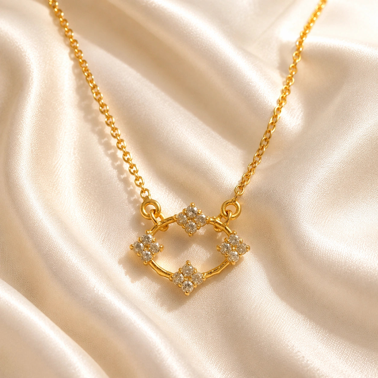Flower_necklace_with_gold_plated_silver_chain_and_labradorite_stones_at_front_angle_view_on_soft_fabric_background
