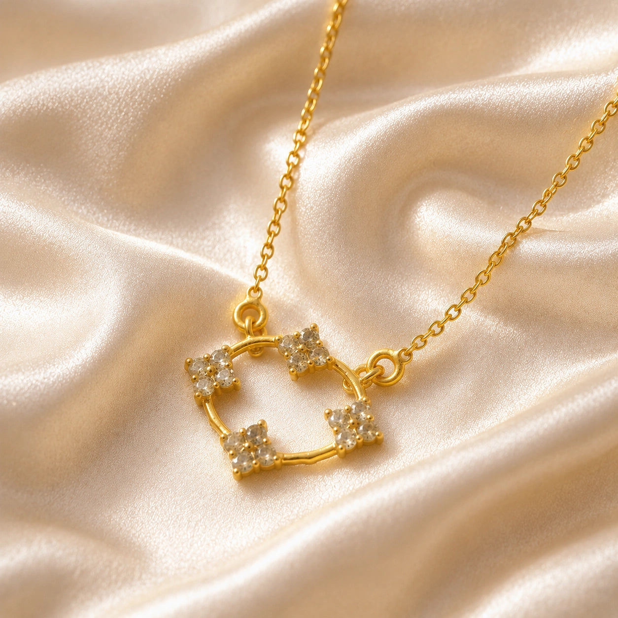 Flower_necklace_with_gold_plated_silver_chain_and_labradorite_stones_at_slight_angled_view_on_soft_fabric_background