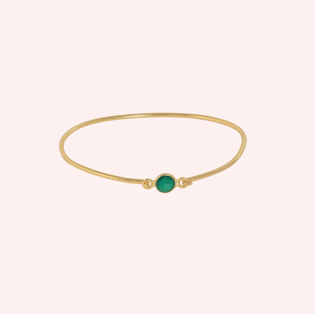 Gemstone_bracelet_in_gold_plated_silver_with_a_round_green_onyx_stone_at_front_angle_view_on_solid_pink_background
