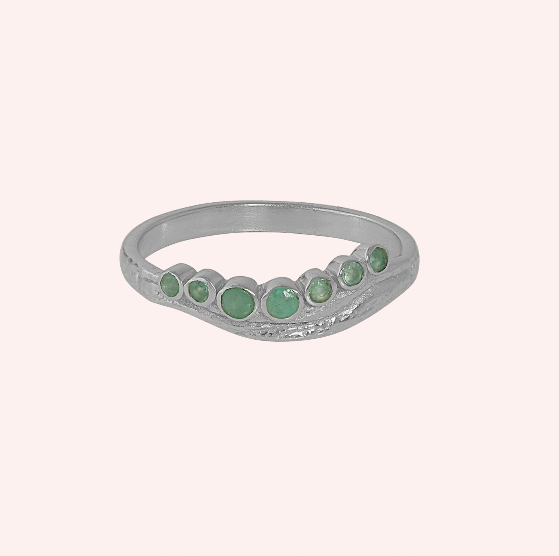 Gemstone_ring_in_sterling_silver_at_front_angle_featuring_amazonite_stones_in_a_curve_design_on_solid_pink_background
