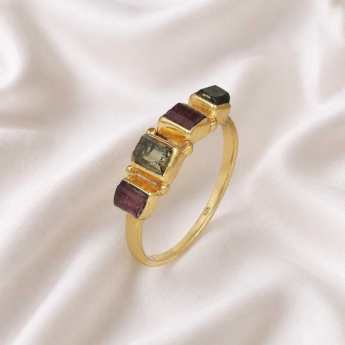 Gemstone_ring_with_tourmaline_stones_in_gold_plated_silver_at_slight_angle_view_on_soft_fabric_background