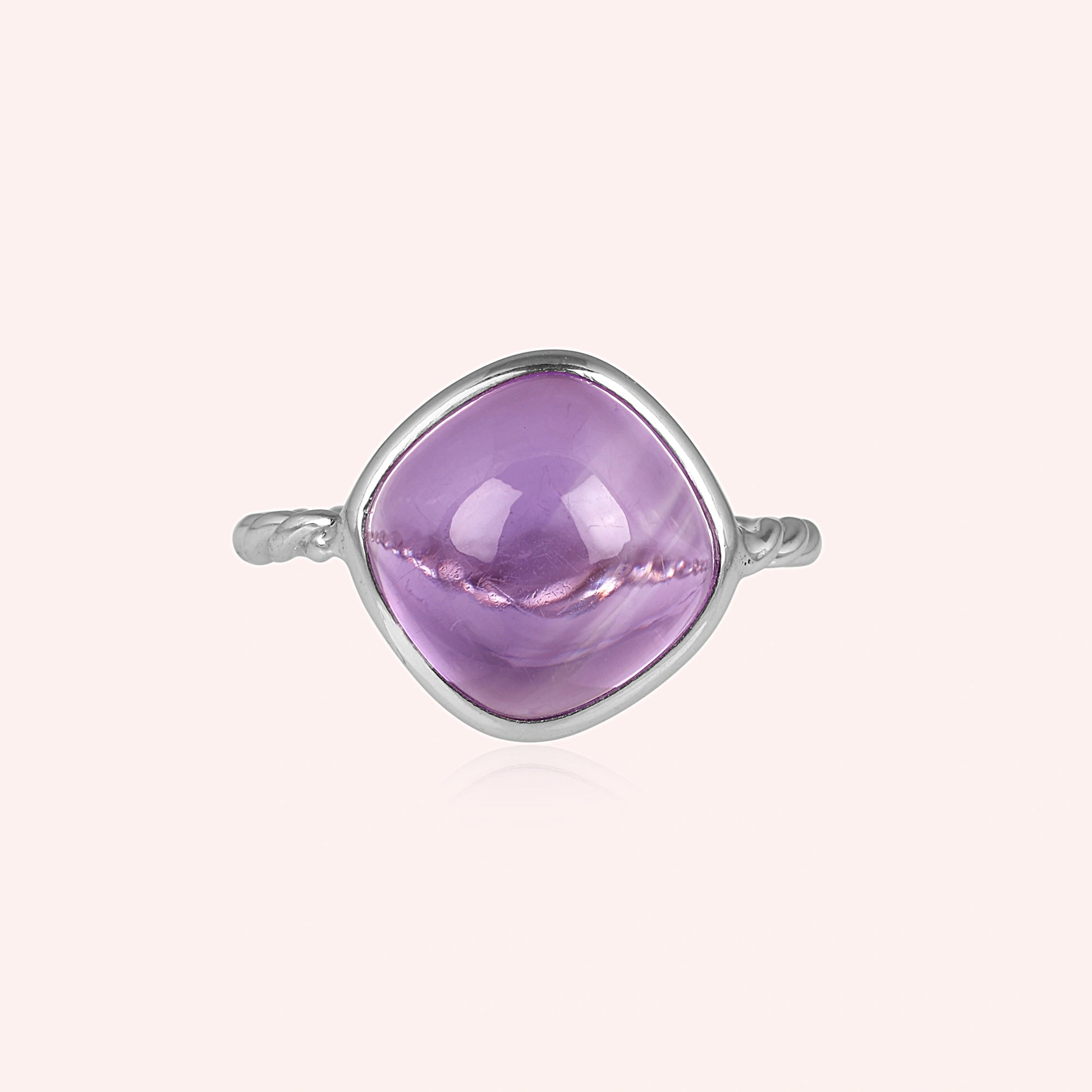 genuine amethyst ring cocktail ring shown at front angled view featuring large purple stone on soft pale background