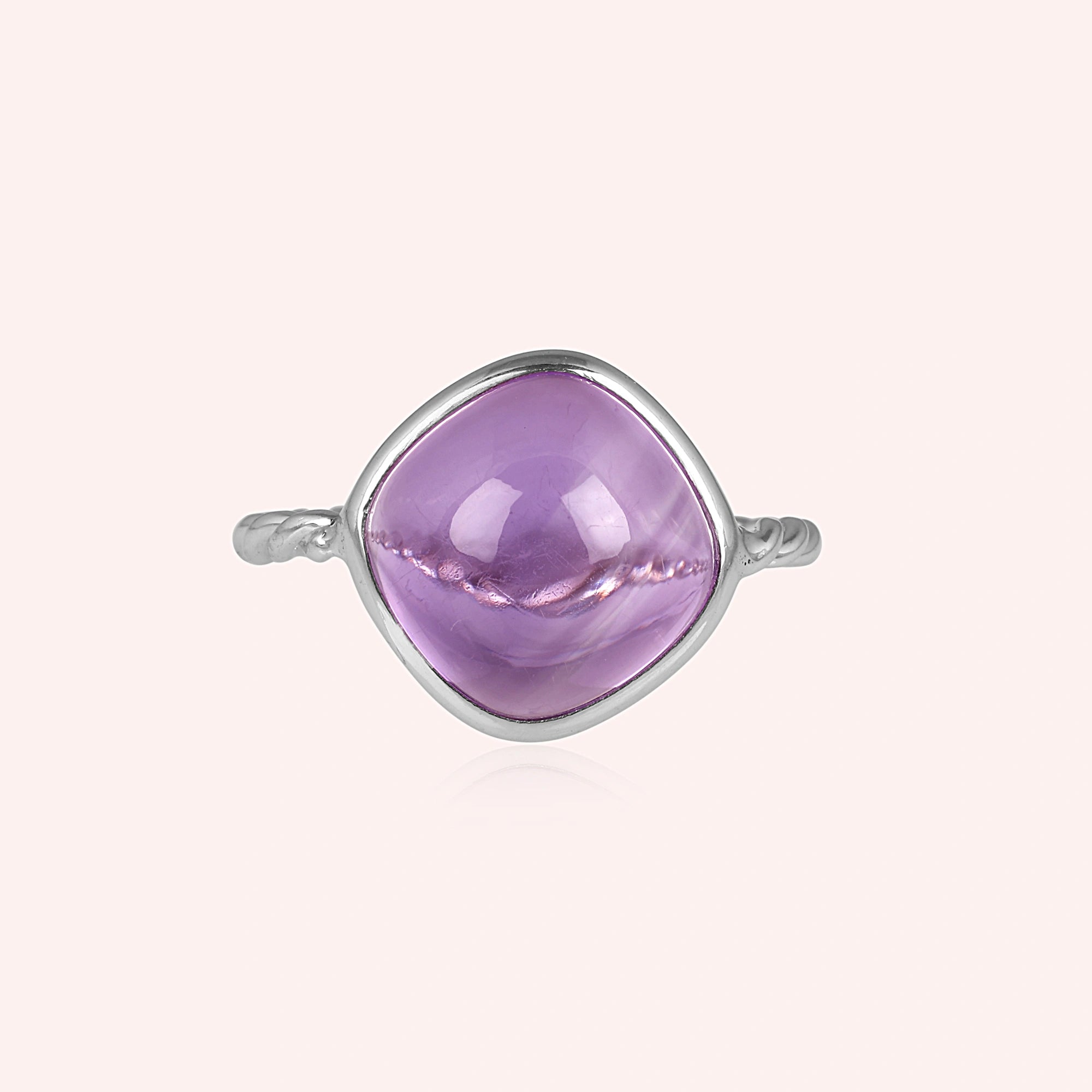 genuine amethyst ring cocktail ring shown at front angled view featuring large purple stone on soft pale background