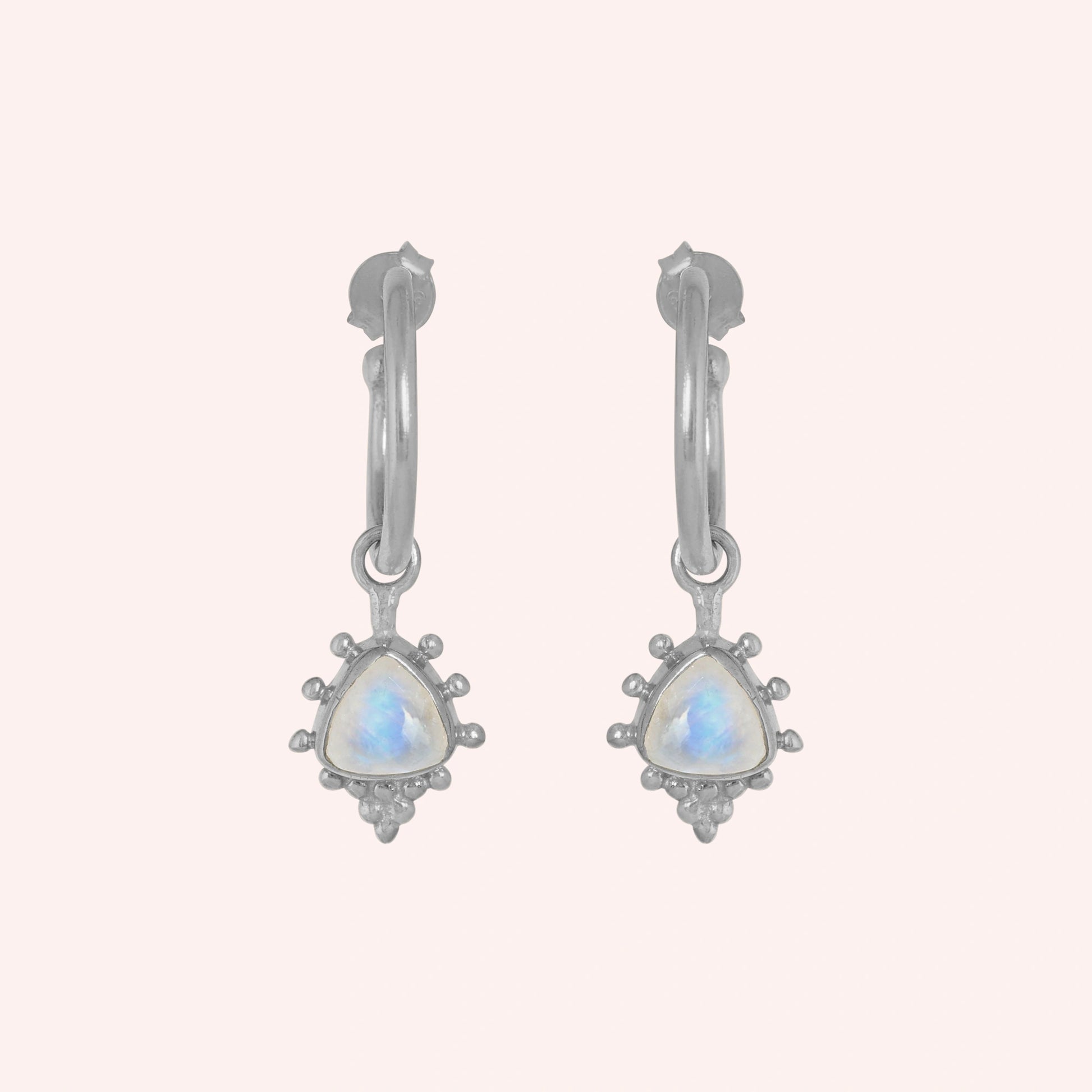 Gold_drop_earrings_in_sterling_silver_at_front_angled_with_triangle_moonstone_charms_on_solid_pink_background