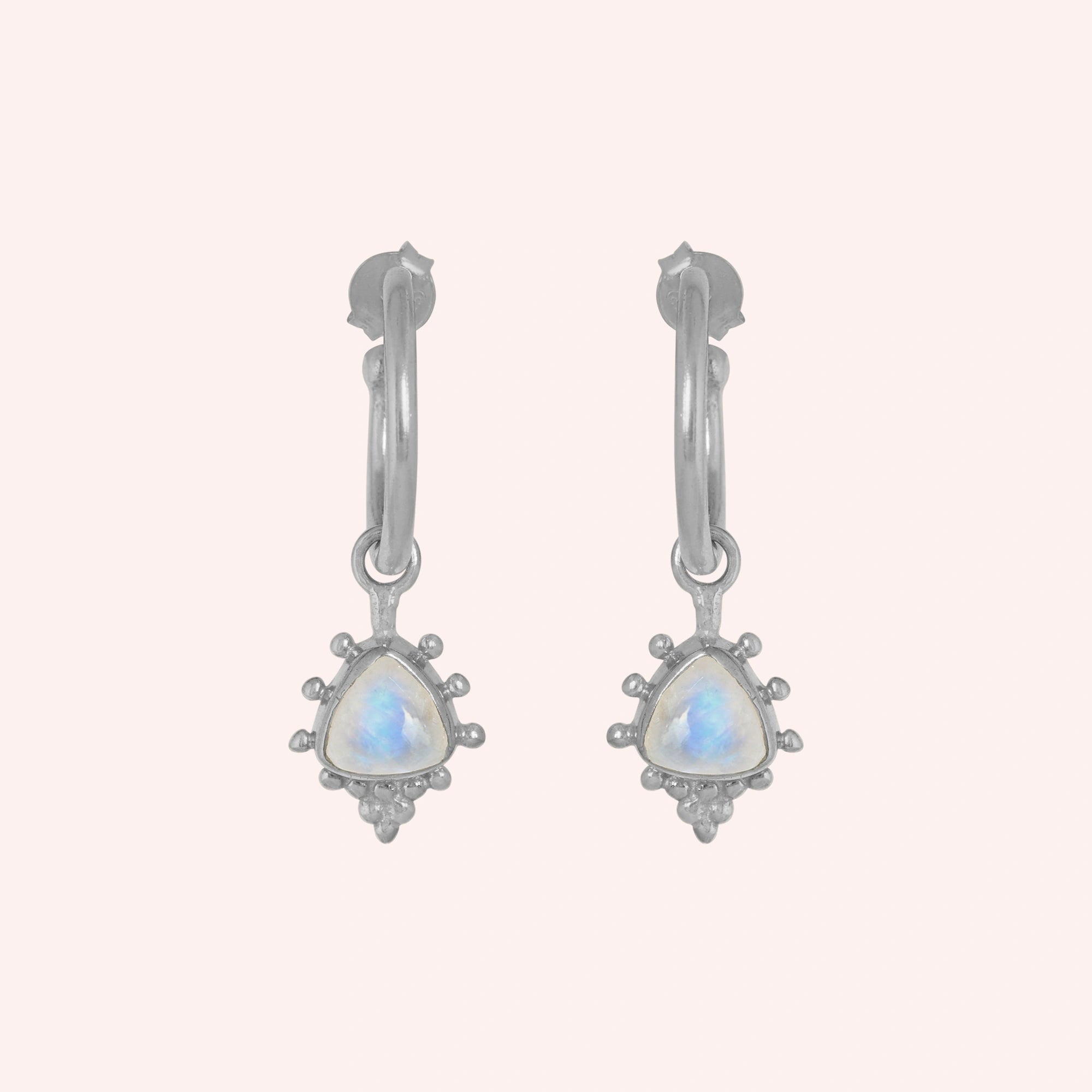 Gold_drop_earrings_in_sterling_silver_at_front_angled_with_triangle_moonstone_charms_on_solid_pink_background