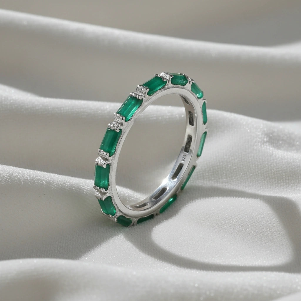 Sterling silver green onyx ring with clear stone accents elevated angle view on softly draped white fabric background