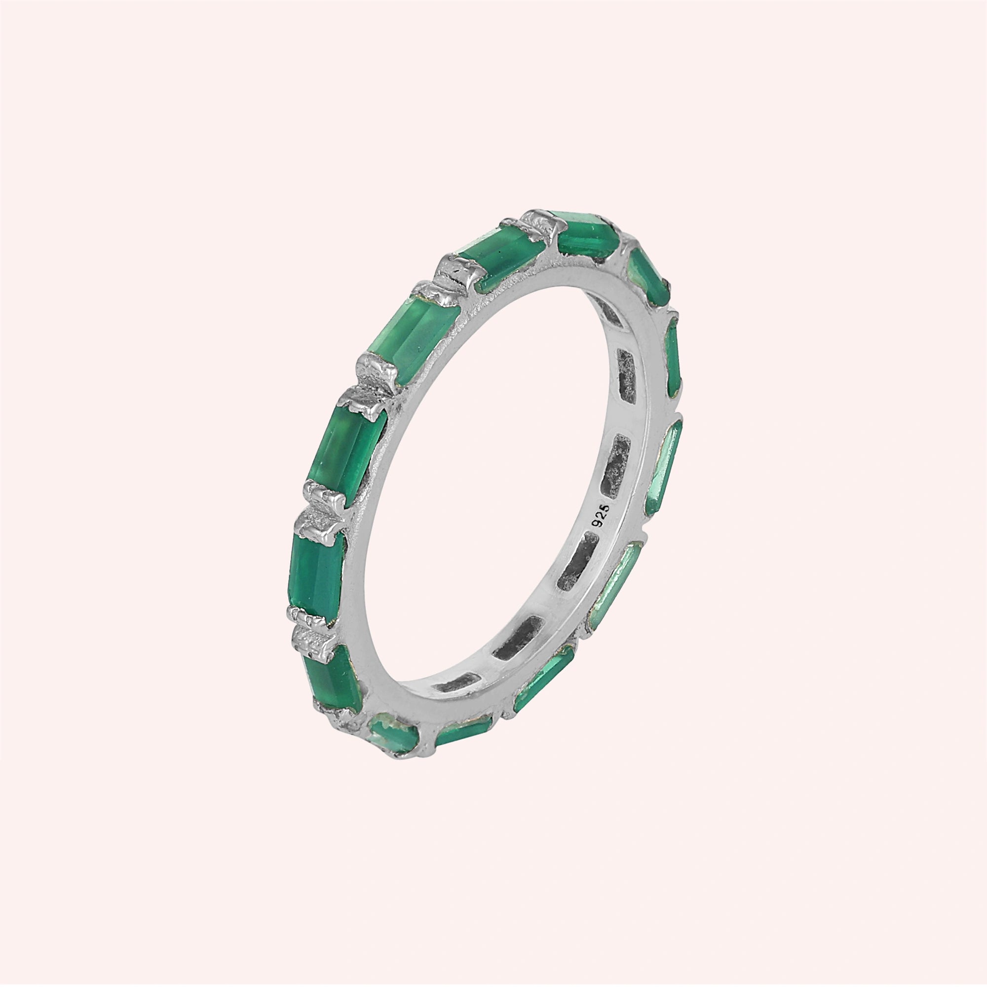 Sterling silver green onyx ring with baguette stones bar set elevated angle view against a solid light pink background
