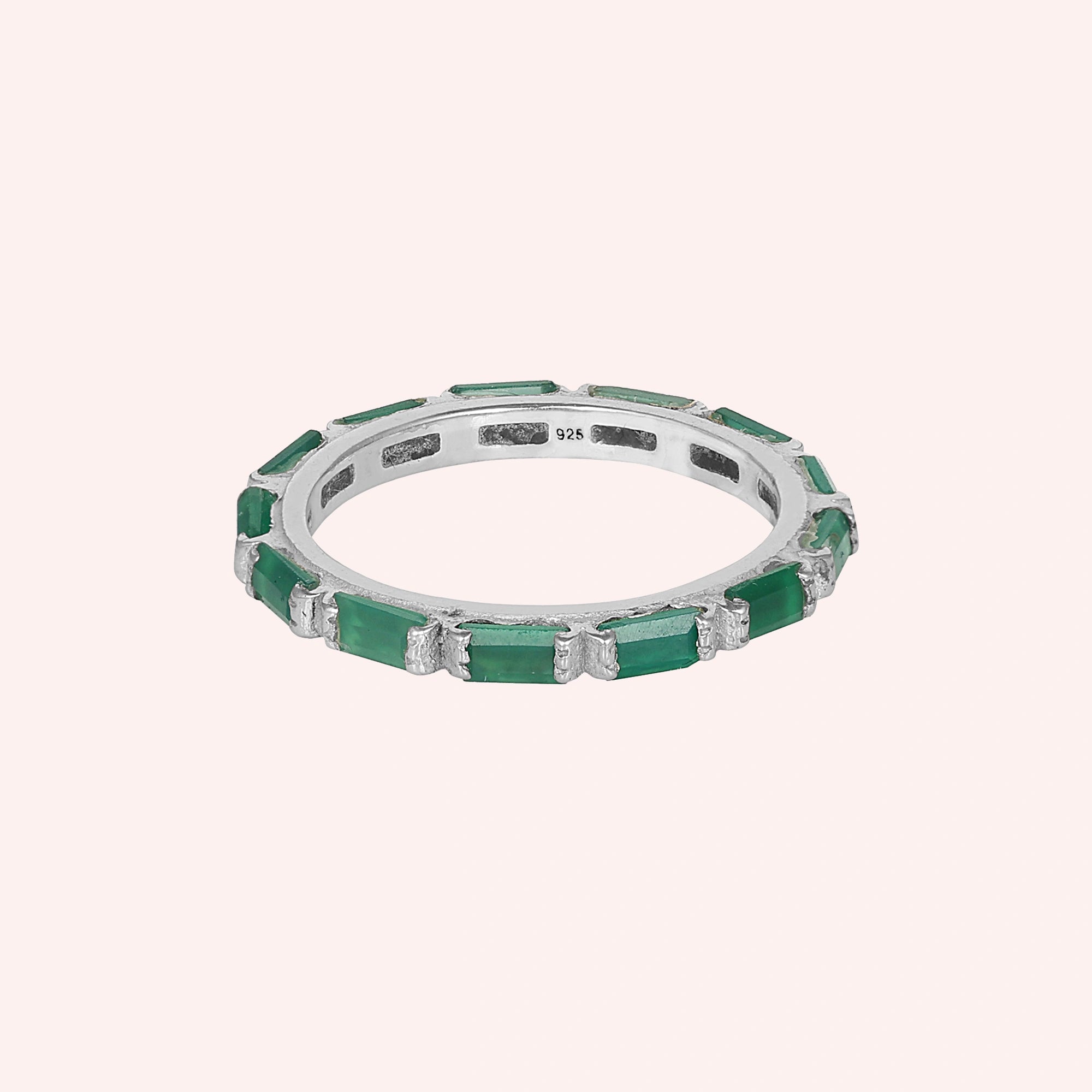 Sterling silver green onyx ring with rectangular stones channel set straight on view against a solid light pink background