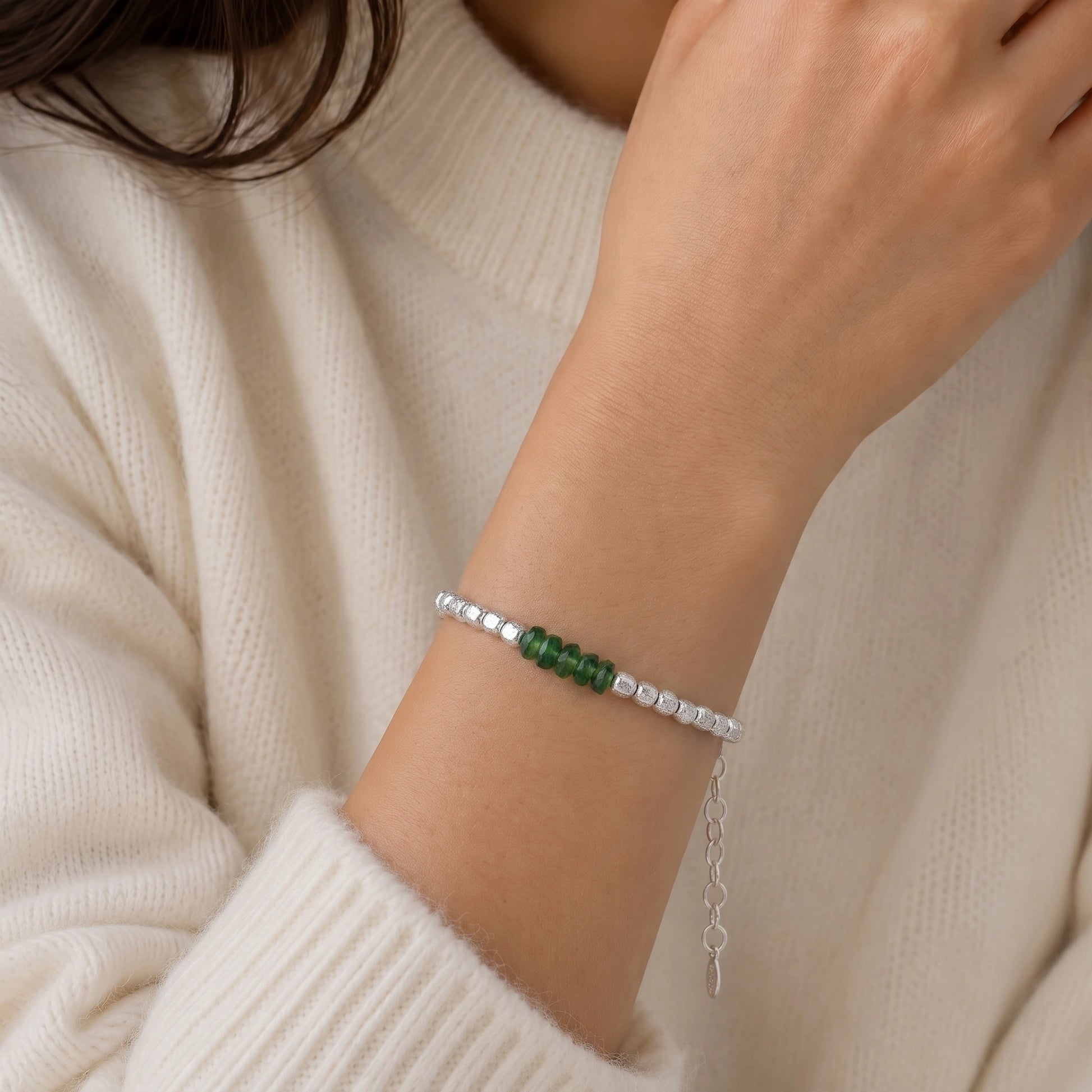 Green_stone_bracelet_with_green_onyx_stones_and_sterling_silver_beads_worn_by_a_model
