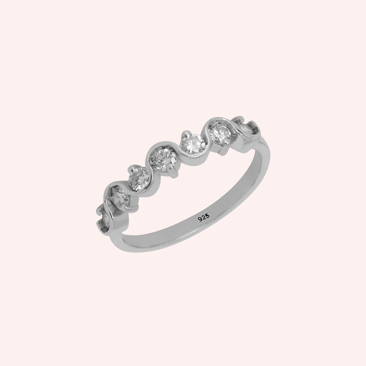 Diamond_ring_in_sterling_silver_with_half_eternity_design_at_side_angle_view_on_solid_pink_background
