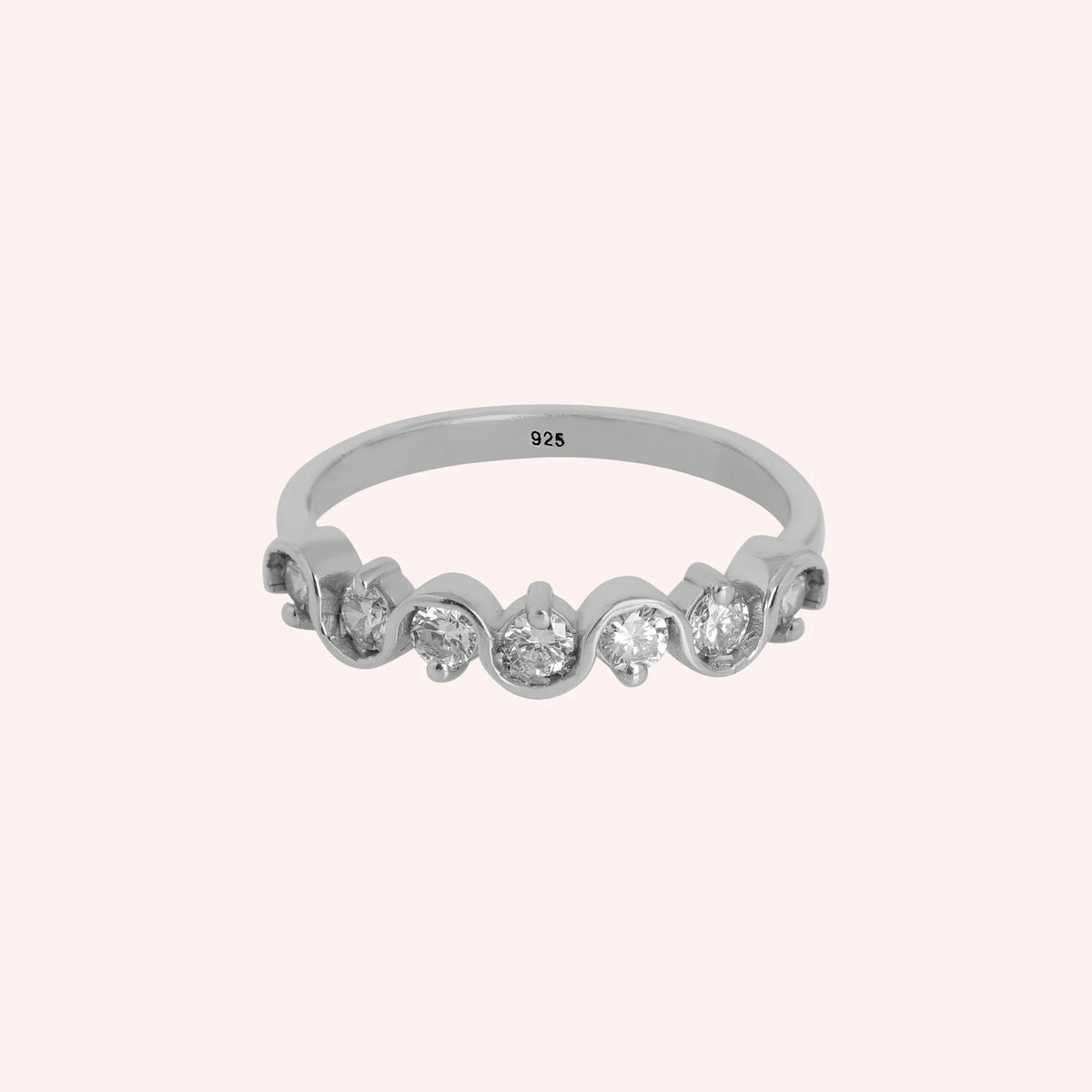 Diamond_ring_in_sterling_silver_with_half_eternity_design_at_front_angle_view_on_solid_pink_background