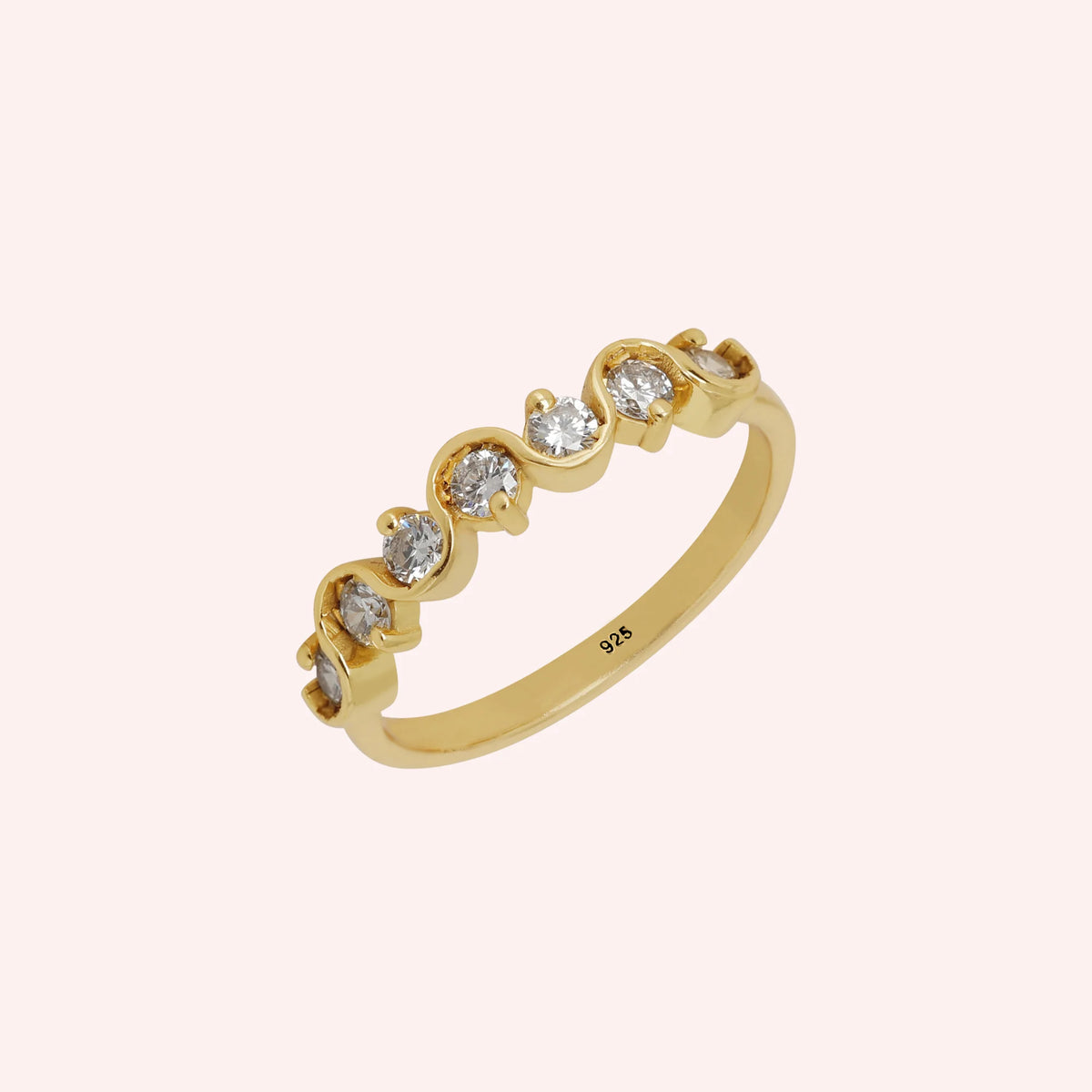 Diamond_ring_in_gold_plated_silver_with_half_eternity_design_at_side_angle_view_on_solid_pink_background