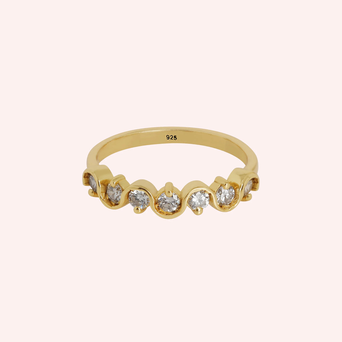 Diamond_ring_in_gold_plated_silver_with_half_eternity_design_at_front_angle_view_on_solid_pink_background