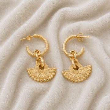Handmade_earrings_in_gold_plated_silver_with_handcrafted_design_hoops_at_front_angle_on_soft_fabric_background