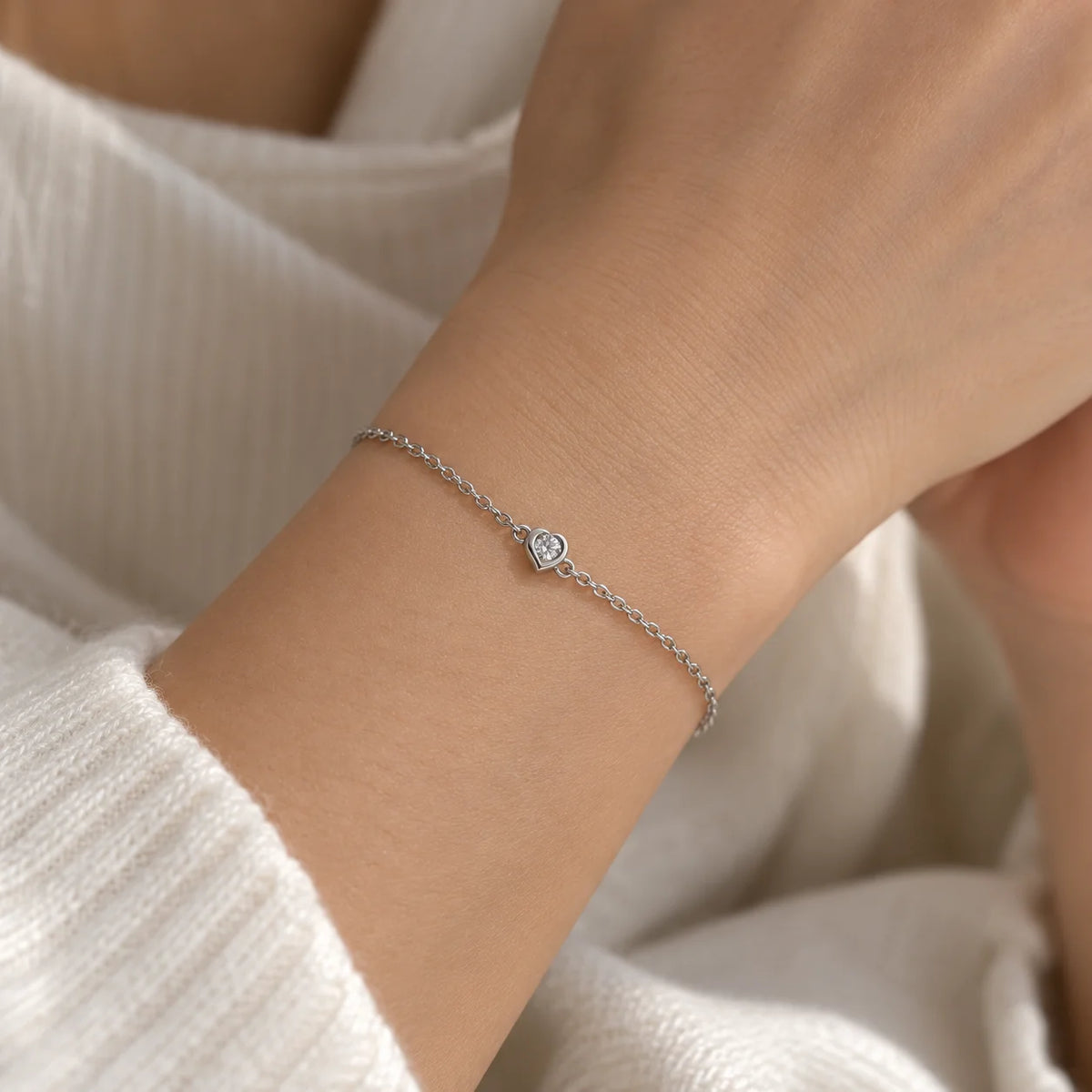 Heart_bracelet_in_sterling_silver_with_a_small_lab_grown_diamond_worn_by_a_model