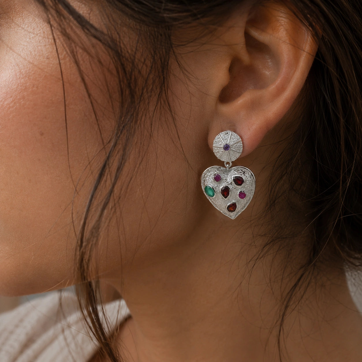 Heart_earrings_in_sterling_silver_with_garnet_ruby_and_green_onyx_stones_worn_by_a_model