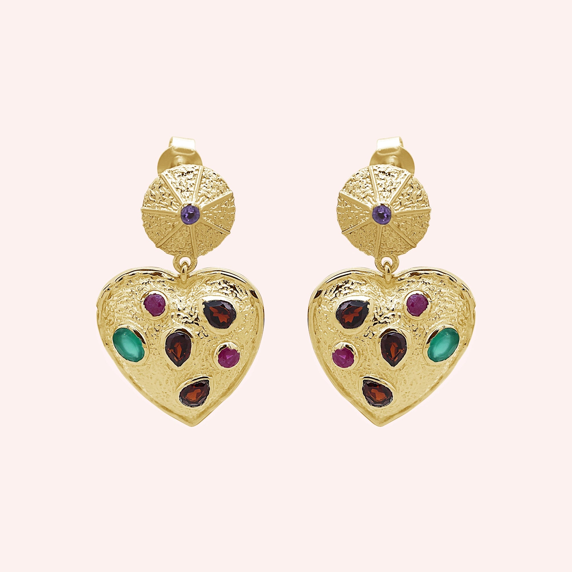 Heart_earrings_in_gold_plated_silver_with_garnet_ruby_and_green_onyx_stones_in_front_angle_on_solid_pink_background