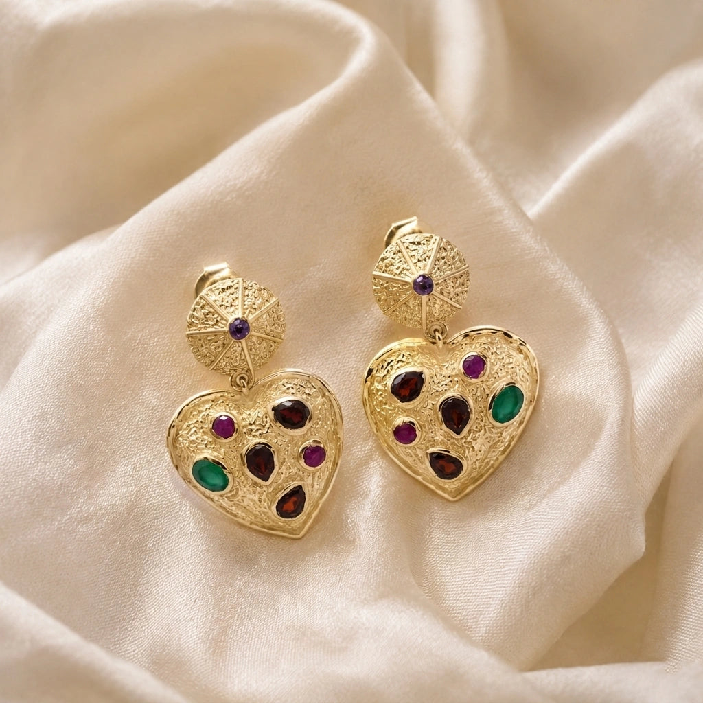 Heart_earrings_in_gold_plated_silver_with_garnet_ruby_and_green_onyx_stones_front_angle_on_soft_fabric_background