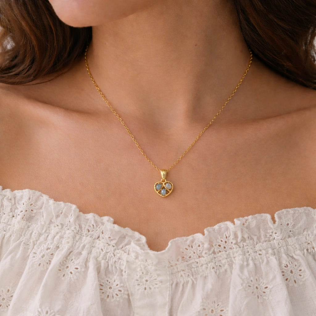Heart_pendant_necklace_with_gold_plated_silver_heart_and_labradorite_stones_worn_by_a_model