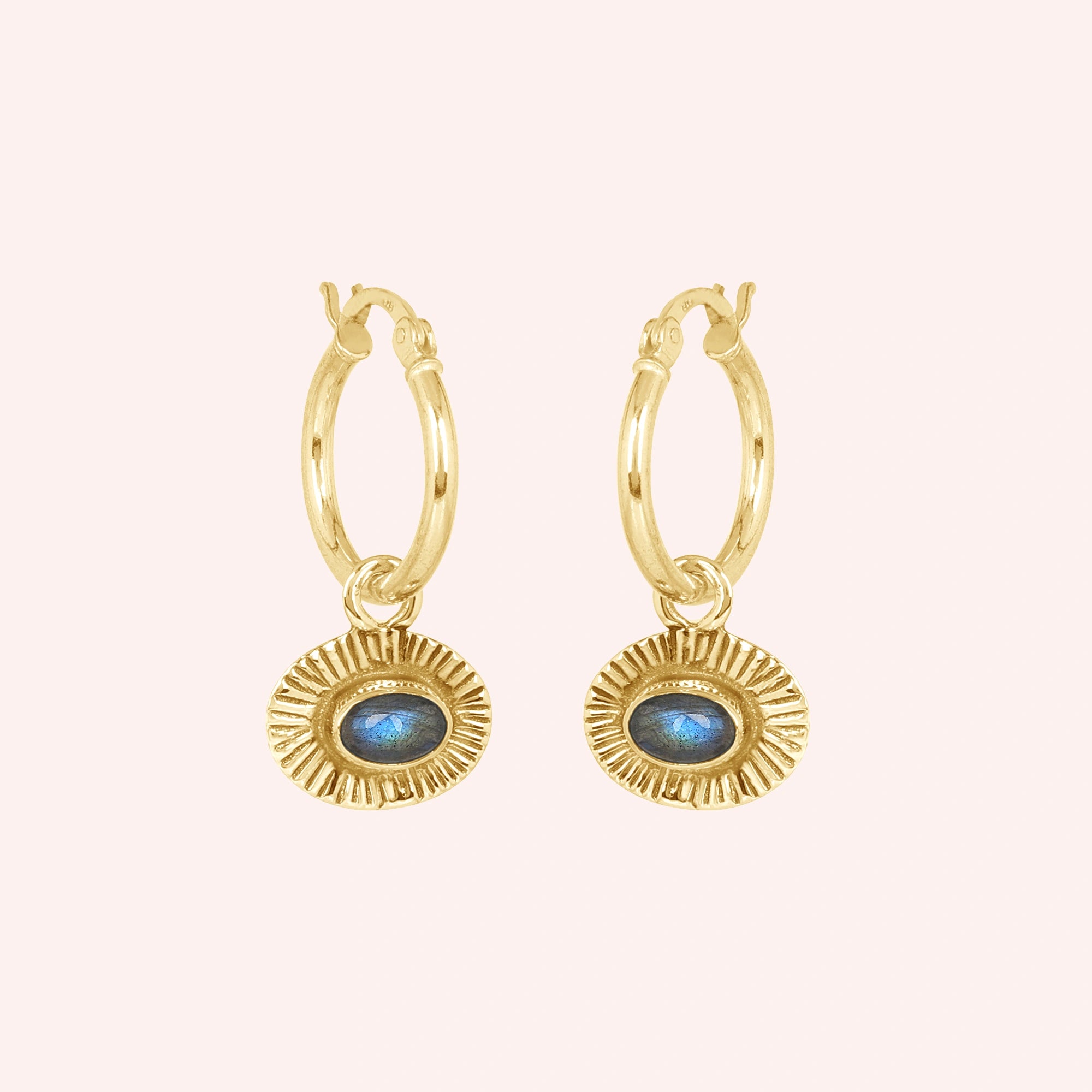 Hoop_earrings_in_gold_plated_silver_with_oval_labradorite_stone_at_front_angle_view_on_solid_pink_background