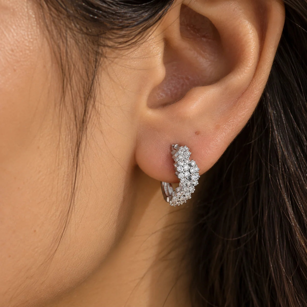 Huggie_earrings_in_sterling_silver_with_lab_grown_diamonds_worn_by_a_model