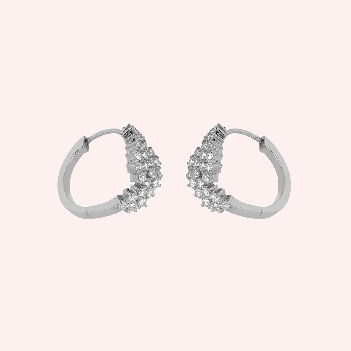 Huggie_earrings_in_sterling_silver_with_lab_grown_diamonds_at_side_angle_view_on_solid_pink_background